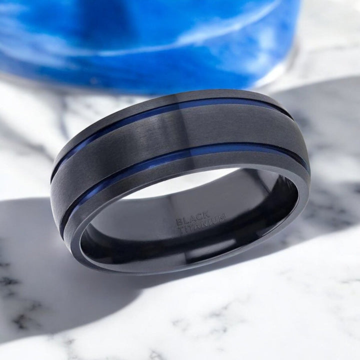 SHERIFF black titanium wedding band featuring sleek domed finish and vibrant blue grooves - Aydins Jewelry.