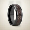 SILURIAN black ceramic ring with brown dinosaur bone inlay running around the band and polished beveled edges, studio hero shot