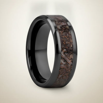 SILURIAN black ceramic ring with brown dinosaur bone inlay running around the band and polished beveled edges, studio hero shot