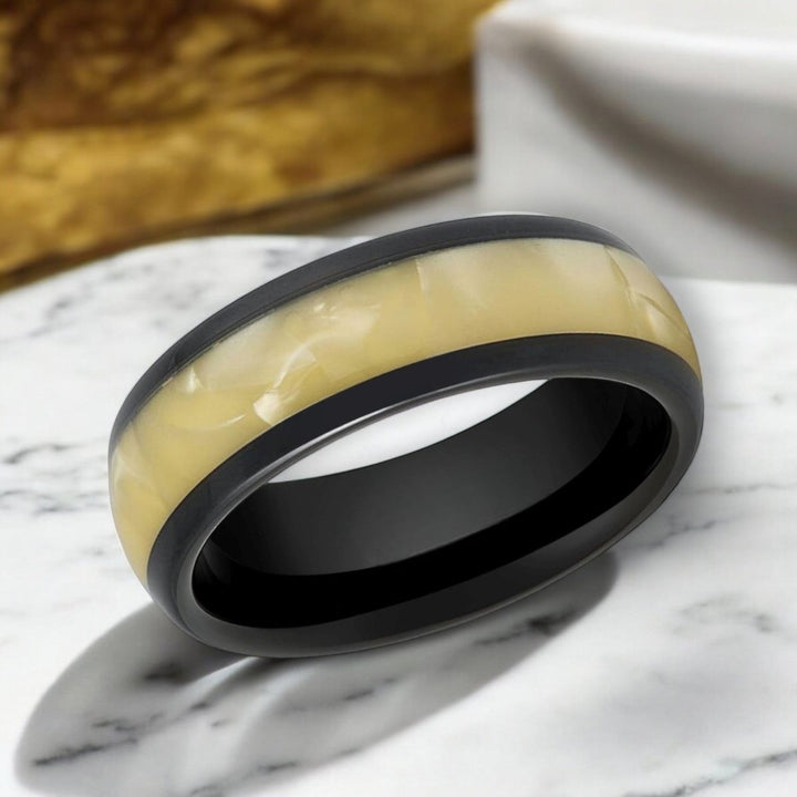 Side view of SOLSTICE Black Tungsten Ring featuring a shimmering golden inlay.