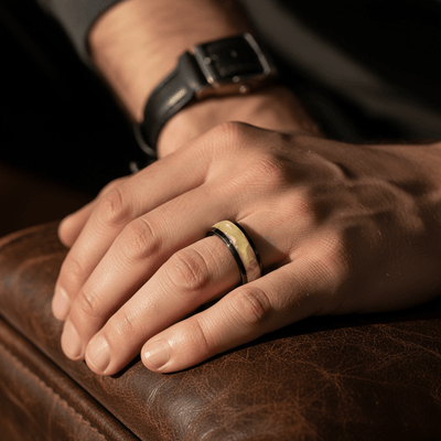 SOLSTICE — Lifestyle photo on hand — men's tungsten wedding ring.