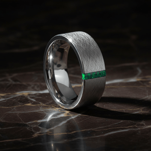 STARK — Luxury 3/4 angle on dark marble — men's tungsten wedding ring.
