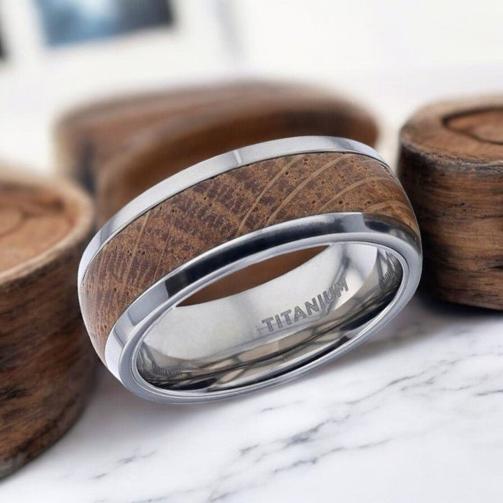 Side view of STAVE titanium ring featuring polished domed edges and whiskey barrel inlay.