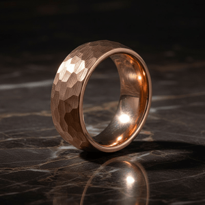 STRIKE — Luxury 3/4 angle on dark marble — men's tungsten wedding ring.
