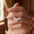 Three Stone Diamond Necklace 925 silver lab grown diamond necklace held in hand lifestyle close-up photo