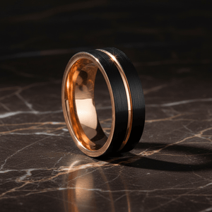 TRISTON — Luxury 3/4 angle on dark marble — men's tungsten wedding ring.