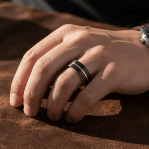 TRISTON — Lifestyle photo on hand — men's tungsten wedding ring.