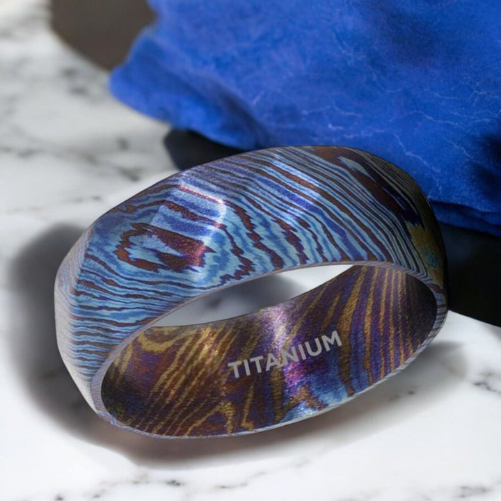 Blue and purple wavy pattern detail on TYRIAN titanium ring