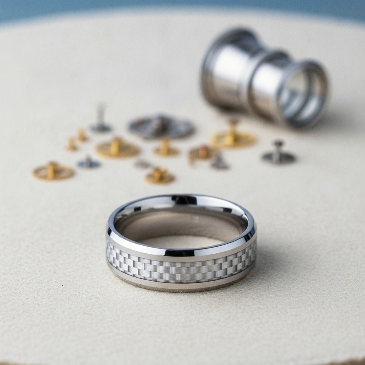 Aydins ULTIMUS | Silver Tungsten Ring, White Carbon Fiber Inlay, Beveled lifestyle scene, watchmaker bench