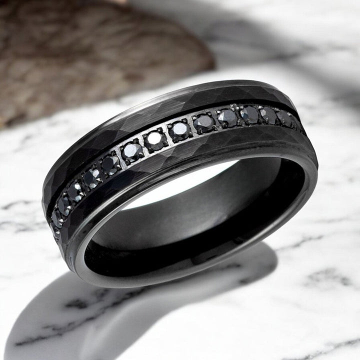 Close-up of VELKARA ring showcasing hammered design and CZ inlay.