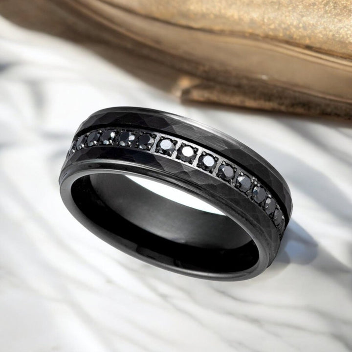 Elegant VELKARA tungsten ring with textured hammered finish and eternity stones.