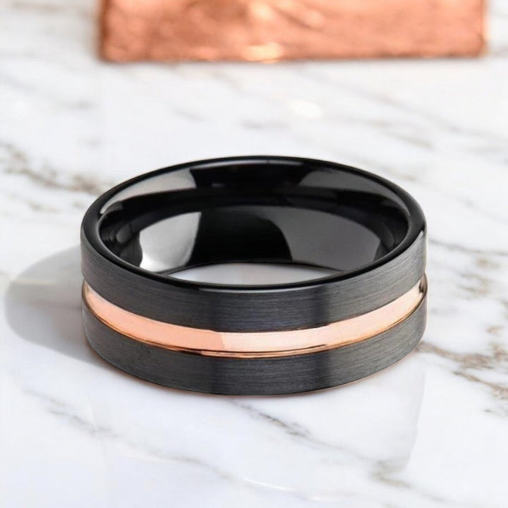 Stylish black ceramic wedding band with brushed flat finish, rose gold groove, and comfort-fit design - Aydins Jewelry.