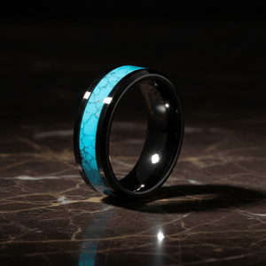 VERDEL — Luxury 3/4 angle on dark marble — men's tungsten wedding ring.