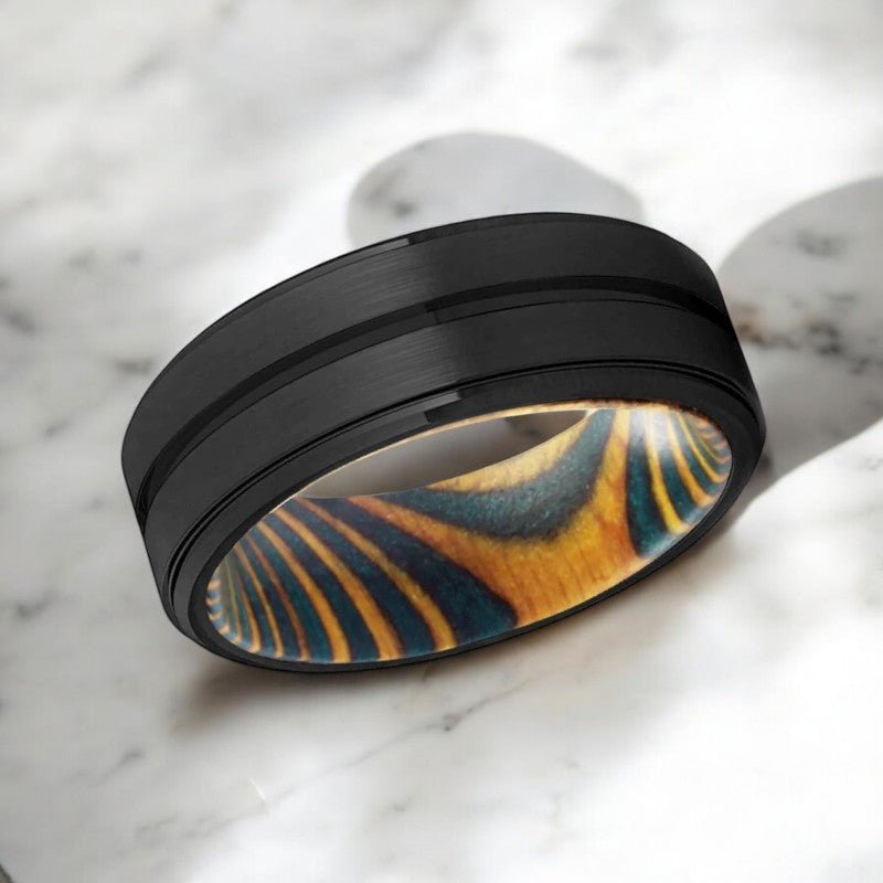 Side view of VERDURE tungsten ring showing grooved band and stepped edge.
