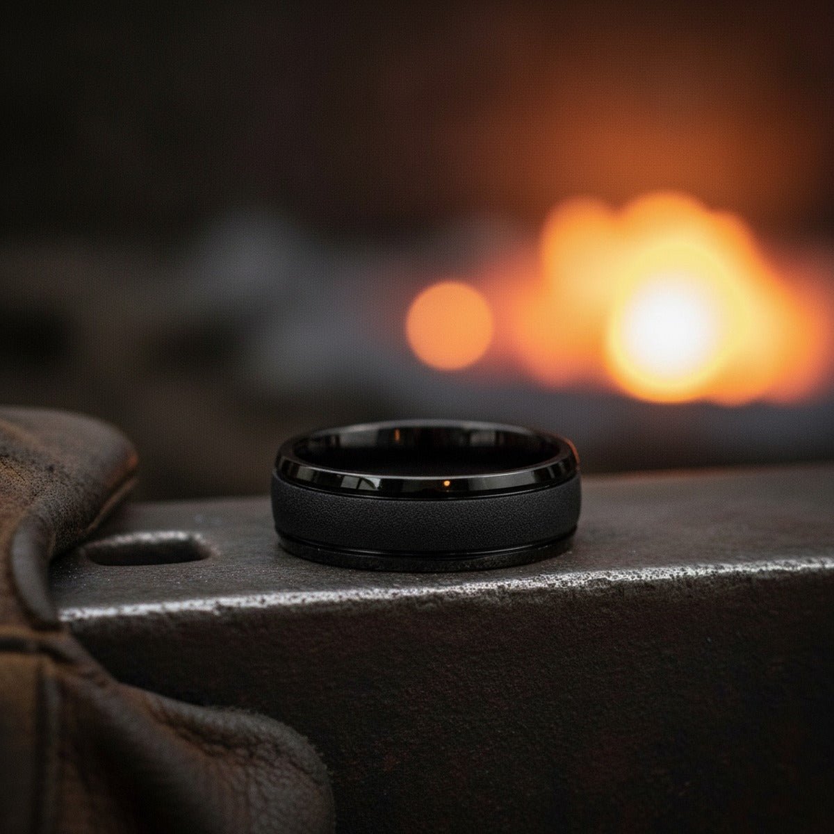 Aydins VORTEX | Black Tungsten Sandstone Texture Domed Wedding Ring 8mm lifestyle scene, blacksmith forge