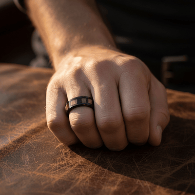 WILDSTRIPE — Lifestyle photo on hand — men's tungsten wedding ring.