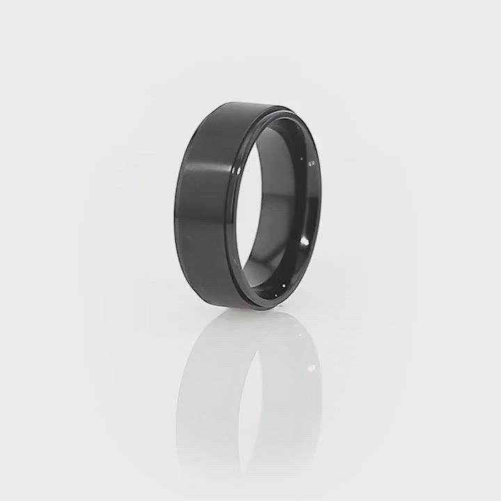 Comfort-fit BABYLON titanium ring showcasing its brushed center and sleek black design