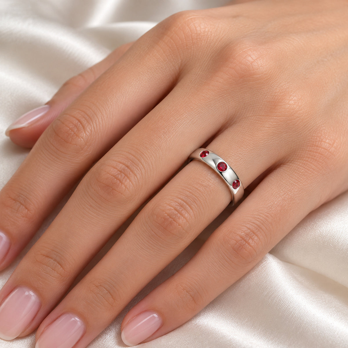 MAERA domed tungsten band with three red rubies, on hand