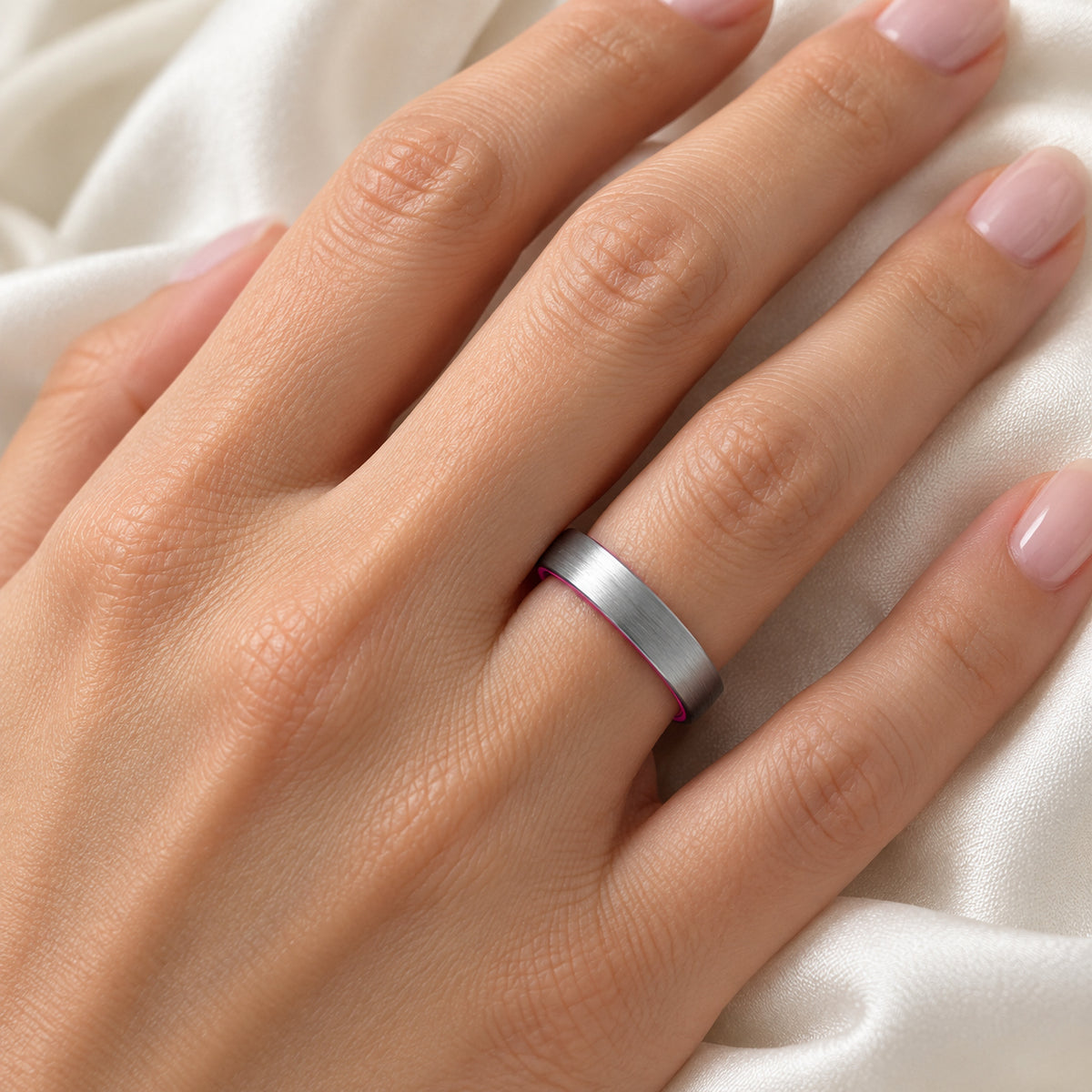 PASSION brushed silver tungsten band with pink interior, on hand